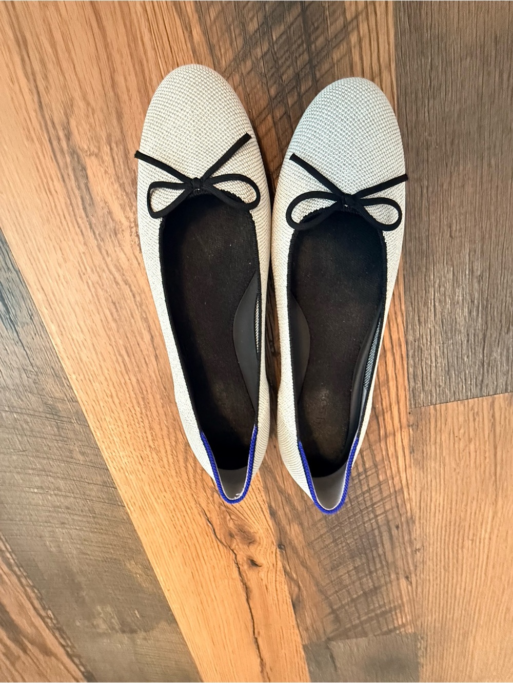 Rothy's Cream Ballet Flats with Black Bow and Blue Trim